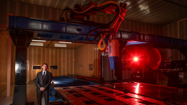 Jeff Lang stands before his new 3D printer at the official unveiling on Wednesday.