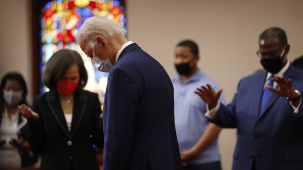 Democratic presidential candidate, former vice-president Joe Biden bows his head in prayer during a visit to Bethel AME Church in Delaware.