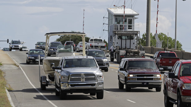 People drive over a drawbridge in Wrightsville Beach, NC as they evacuate the area in advance of Hurricane Florence.