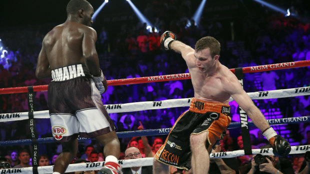 Terence Crawford, left, knocks Jeff Horn, of Australia, off balance.