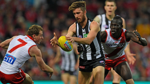 Pressure in defence: Aliir Aliir tries to prevent Tom Phillips of the Magpies from clearing the ball.