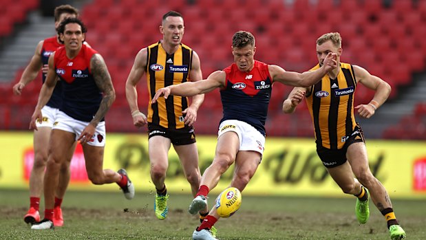 Kicking on: Jake Melksham helps the Demons surge forward against Hawthorn at Giants Stadium in Sydney.