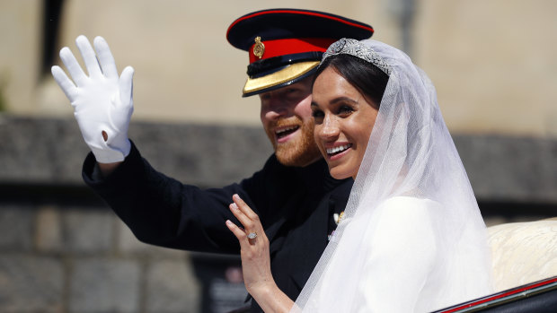 Beneath a bluebird sky, the newly married couple take a ride in a horse-drawn carriage.