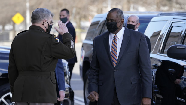 Defence Secretary Lloyd Austin, right, is saluted by Chairman of the Joint Chiefs of Staff Mark Milley as he arrives at the Pentagon.