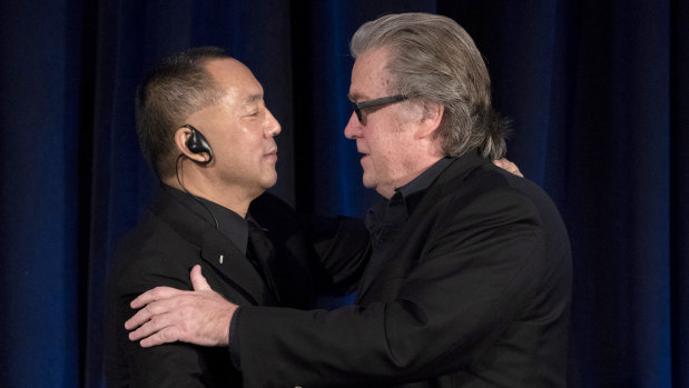 Former White House chief strategist Steve Bannon, right, greets fugitive Chinese billionaire Guo Wengui before introducing him at a news conference on November 20 in New York.