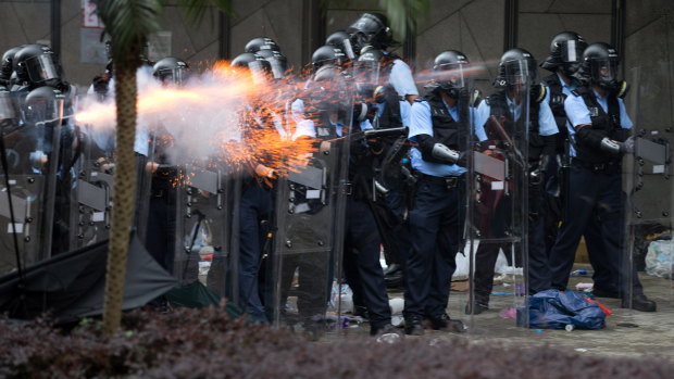 Police shooting tear gas at protesters during the rally against an extradition bill outside the Legislative Council.