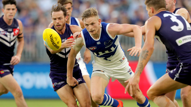 North Melbourne's Jack Ziebell hunts the ball on a night of scarcity at Optus Stadium against Fremantle. 