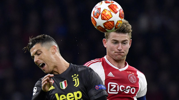 Matthijs de Ligt fights for the ball with Juventus' Cristiano Ronaldo, who is now his teammate. 