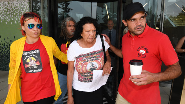 Leetona Dungay (centre) is supported at the NSW Coroners Court on Friday.