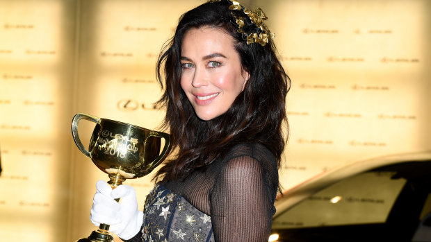 Megan Gale poses for a photograph with the Melbourne Cup last year. This year she will not attend.