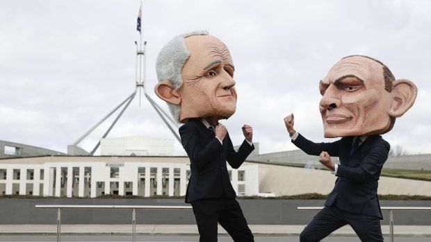 Puppets of Malcolm Turnbull and Tony Abbott pose for photographers during a renewable energy event organised by GetUp on the lawn of Parliament House on Tuesday morning.