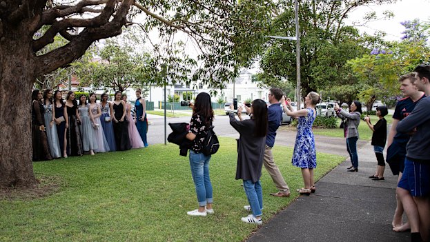 Parents and siblings look on as students from Strathfield Girls High School head to their school formal.