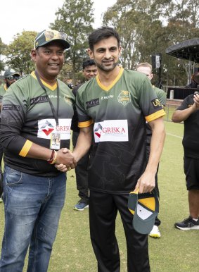 Former Pakistan cricketer Shoaib Malik receives his cap.