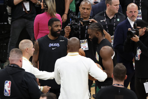 Kyrie Irving (left) and Jaylen Brown chat pregame.