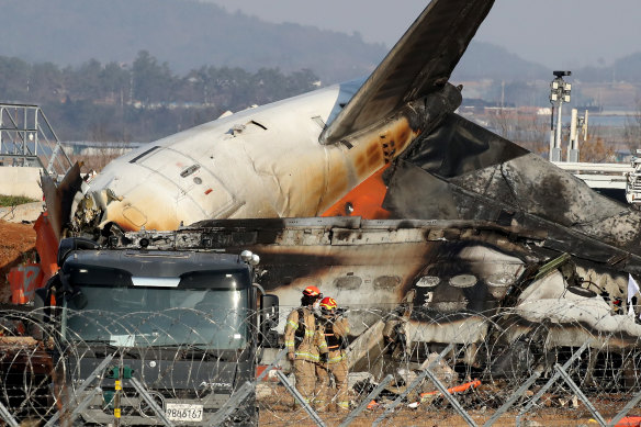 Firefighters and rescue teams at the plane wreckage at Muan International Airport, South Korea. 