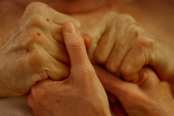 Anjelika Elliott holds her husband Dr John Elliott’s hands in a Zurich hotel room a day before going to the Dignitas clinic where he ended his life in 2007. The Sydney couple travelled to Switzerland, where assisted dying is legal.