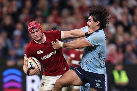 Josh van der Flier of the British and Irish Lions is tackled by Waratah Charlie Gamble during a tour match last year at Allianz Stadium