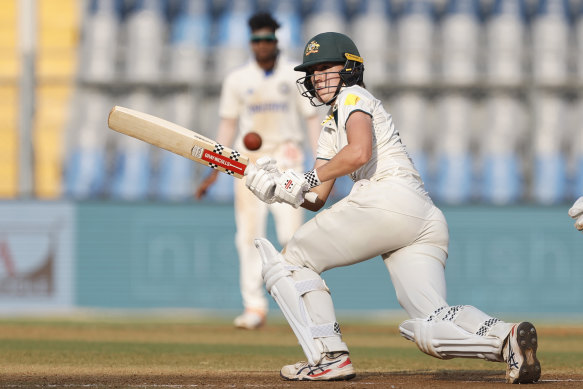 Sutherland plays a sweep shot as Australia builds a slender lead over India.