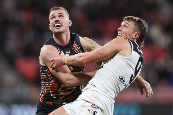 Kieren Briggs of the Giants competes for the ball against Patrick Cripps of the Blues