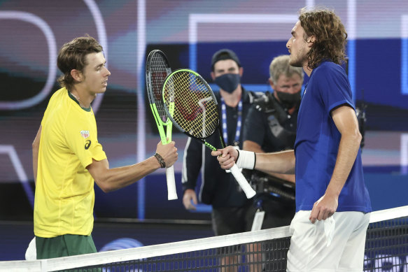 Greece’s Stefanos Tsitsipas, right, is congratulated by Australia’s Alex de Minaur, left, at Melbourne Park. 