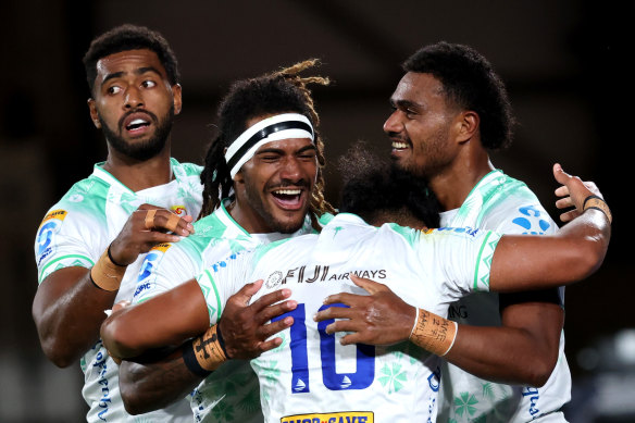 Fijian Drua players celebrate after scoring a try against the Chiefs in round four