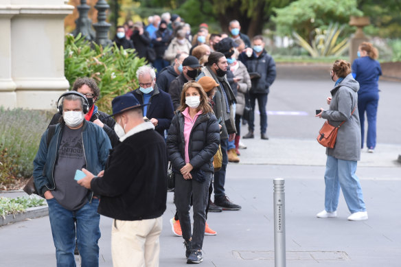People line up for COVID-19 vaccinations at Melbourne’s Exhibition Building in Carlton. 