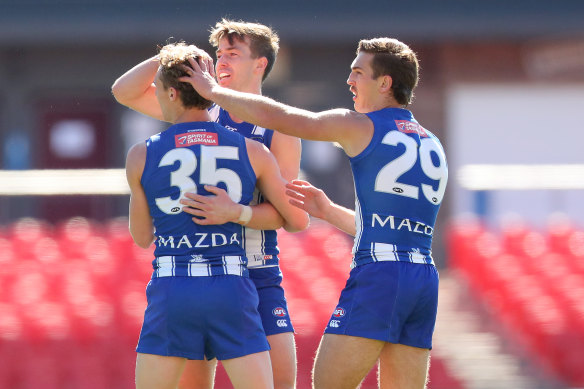Young Kangaroos Charlie Lazzaro celebrates a goal with teammate Will Phillips 