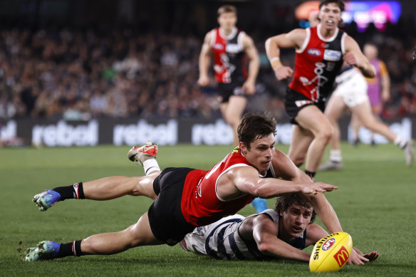 Jack Steele of the Saints competes with Gryan Miers of the Cats.