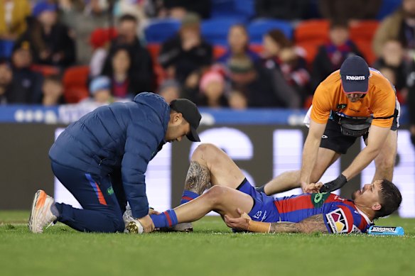 Trainers assist Dylan Lucas.