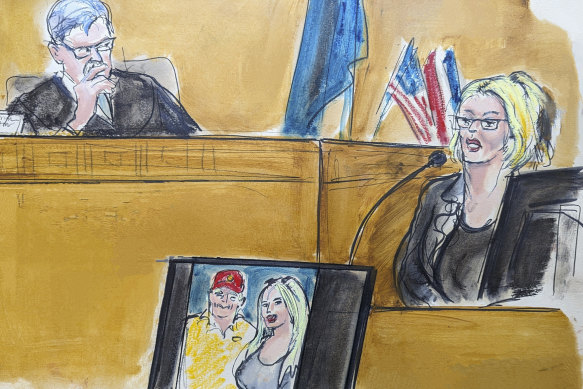 In this courtroom sketch, Stormy Daniels testifies on the witness stand as Judge Juan Merchan looks on.