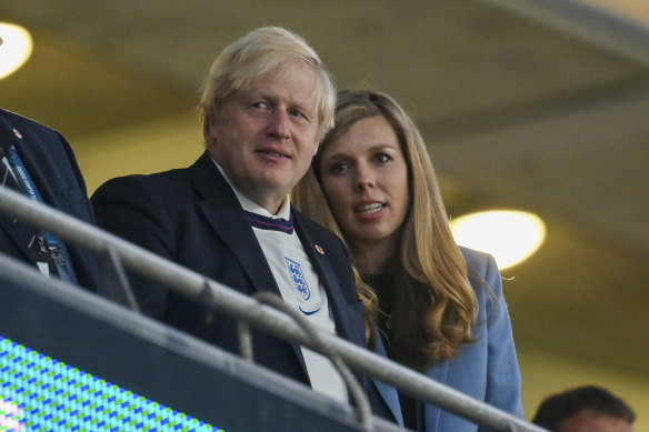 British Prime Minister Boris Johnson and his wife, Carrie, watch England celebrate after defeating Denmark in their Euro 2020 soccer championship semifinal at Wembley stadium in London in July.