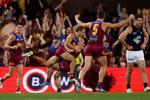 Kai Lohmann and Lachie Neale celebrate a goal.