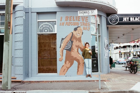 Jet Black Cat Music owner Shannon Logan out the front of her indie record store on Vulture and Thomas Street in West End. The mural was painted by George Levi for Record Store Day in 2019. 