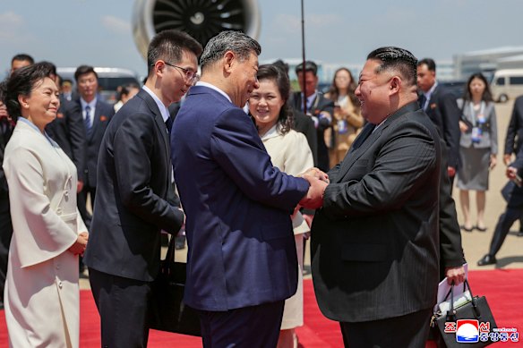 Chinese President Xi Jinping shakes hands with North Korean leader Kim Jong-un at the official welcoming ceremony in Pyongyang, in an image released by KCNA state media.