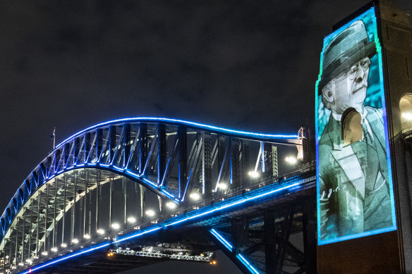 John Bradfield, the chief engineer of the Sydney Harbour Bridge, 
 illuminated on the bridge’s pylons to celebrate its 90th birthday.  