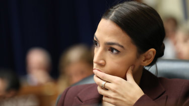 Representative Alexandria Ocasio-Cortez, a Democrat from New York, listens during a House Oversight Committee hearing with Michael Cohen.