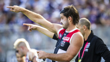 Synchronised signalling: Saint Josh Bruce helps out with pointers from the sidelines.