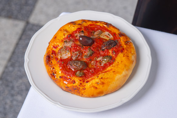 Ligurian-style pizza topped with tomato, olives, capers and anchovies.