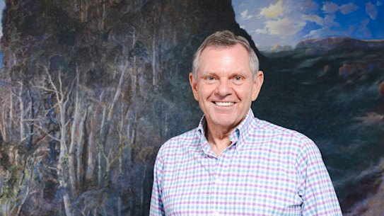 Phillip Bacon with a paintong from his private collection, Passage of Light from the Sea at Numinbah, 2002, by William Robinson “I think he’s certainly Queensland’s greatest artist, but he’s probably the greatest living Australian landscape painter.”