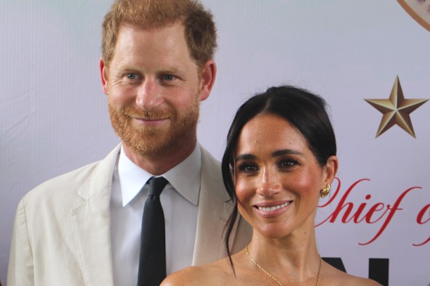Britain's Prince Harry, Duke of Sussex, and Britain's Meghan, Duchess of Sussex, pose for a photo as they attend the program held in the Armed Forces Complex in Abuja, Nigeria on May 11, 2024.