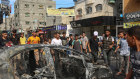 Young Palestinians chant and celebrate atop a car that was burned after being taken from Israeli territory and brought back to Gaza.