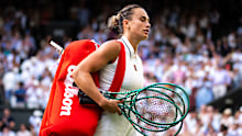Aryna Sabalenka walks off after losing at Wimbledon.