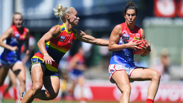 Libby Birch of the Demons and Erin Phillips compete for the ball.