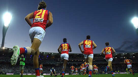 Before the bounce: The Brisbane Lions run onto GMHBA Stadium to play the Cats on Friday night.