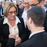 Jacinta Allan, alongside deputy prime minister Richard Marles talks with a member of the Jewish community.