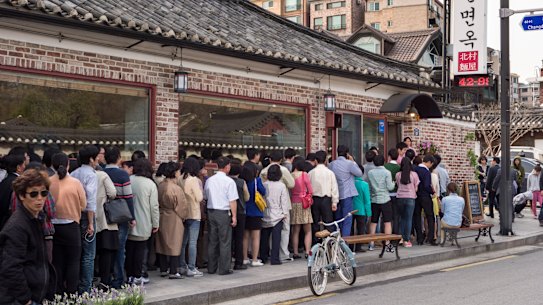 Customers queue outside a popular restaurant in Seoul, South Korea.