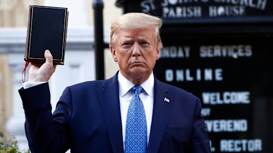 US President Donald Trump holds a Bible as he visits outside St John's Church across Lafayette Park from the White House on Monday.