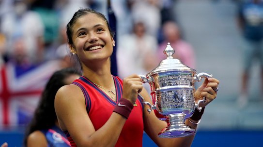 Emma Raducanu of Britain holds up the US Open championship trophy after defeating Leylah Fernandez, of Canada, during the women’s singles final of the US Open tennis championships.