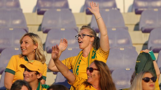 Vibe: A knot of Socceroos fans gets into the spirit at Khalifa bin Zayed Stadium.