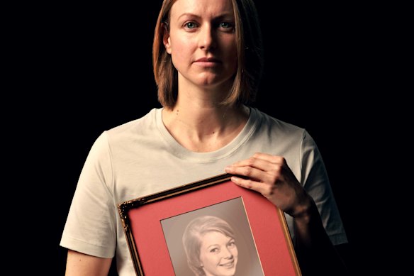 Kathryn Joy holds an image of their mother, who was killed in the family home by Joy’s father.